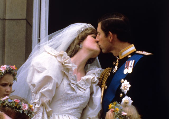 Prince and Princess of Wales kissing on the balcony of Buckingham Palace after their wedding ceremony at St. Paul’s cathedral