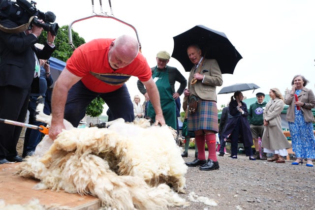 The King watches a sheep being sheared