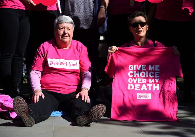 Activists from the Campaign for Dignity in Dying outside the Royal Courts of Justice in London (Kirsty O'Connor/PA)