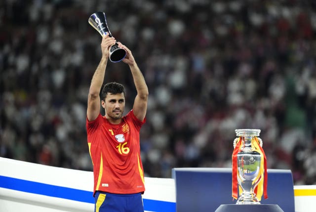 Spain’s Rodri with the Player of the Tournament trophy after winning the Euro 2024 final