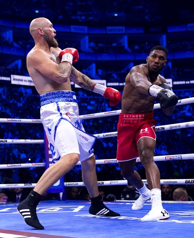 Anthony Joshua, right, throws a right hand at Robert Helenius