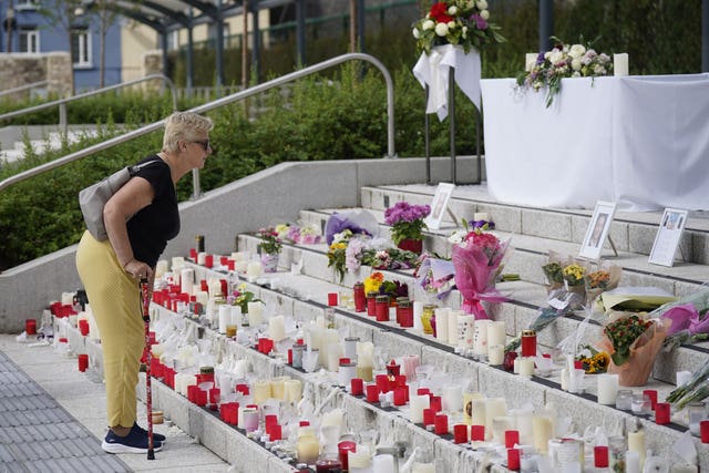 A woman looking at tributes at Kickham Plaza, Co Tipperary