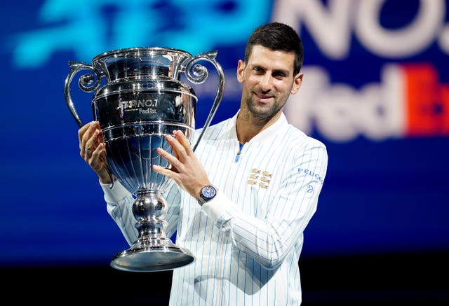 Novak Djokovic poses with his year-end ATP number one trophy