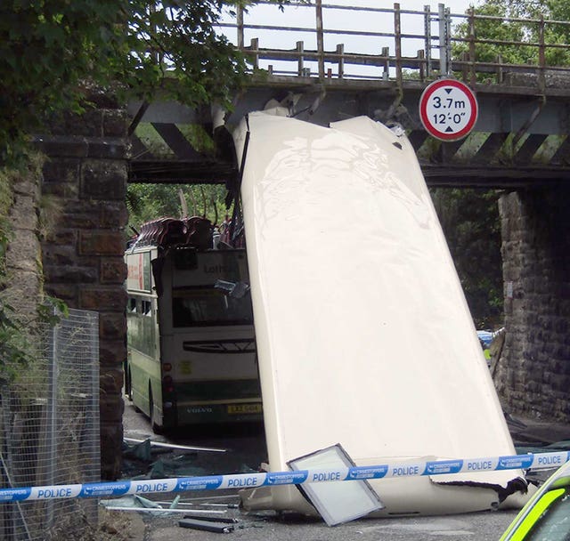 A double decker Lothian country bus that lost its roof after it hit a railway bridge in Shotts Road in Fauldhouse, West Lothian