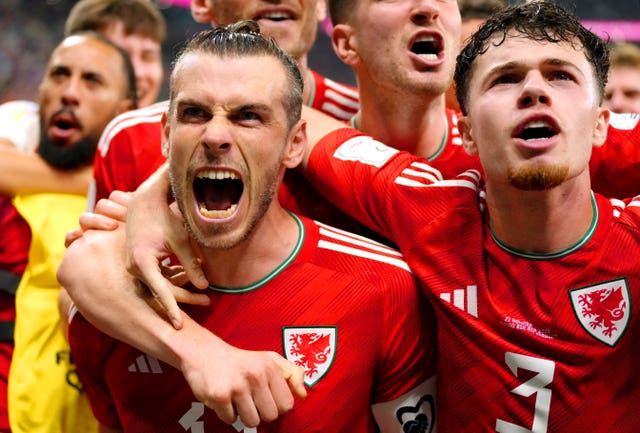 Bale (bottom left) celebrates with his team-mates after his penalty (Nick Potts/PA).