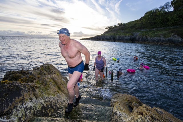 Open water swimmers take an early morning dip at Brompton in Bangor, County Down, after restrictions in Northern Ireland eased