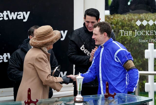 Jockey Paul Townend shakes hands with the Queen Consort as she presents the trophy following Energumene’s victory in the Betway Queen Mother Champion Chase (Tim Goode/PA)