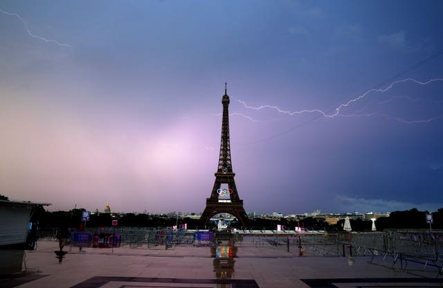 A general view of the Eiffel Tower with ligtning around it.