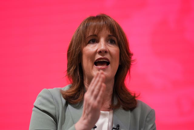Chancellor Rachel Reeves in front of a red backdrop taking part in a Q&A session