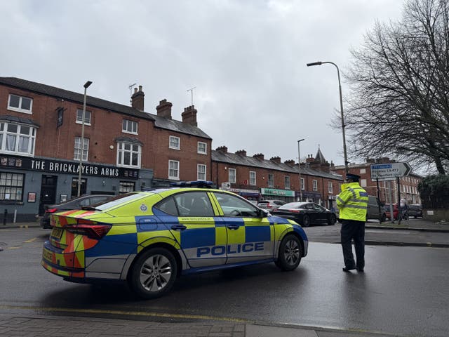 A police car and police officer on a street