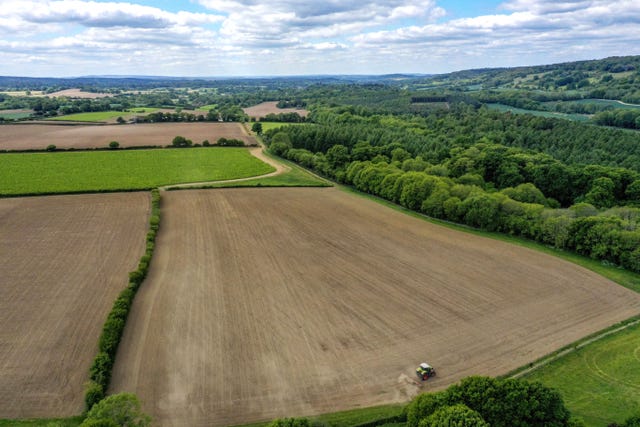 A farmer works in a field at Wotton, near Dorking in Surrey