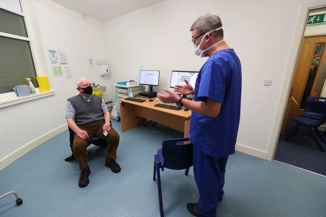 Robert Salt receives the first dose of the vaccine to be delivered at Andrews Pharmacy