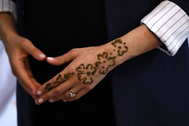 Meghan's left hand is decorated by a henna tattoo