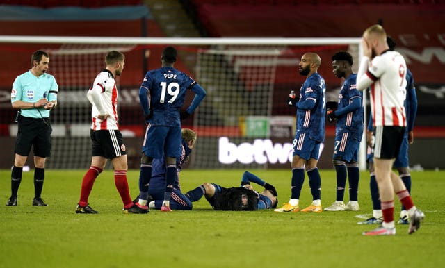 Gabriel Martinelli, centre, receives treatment shortly before his goal