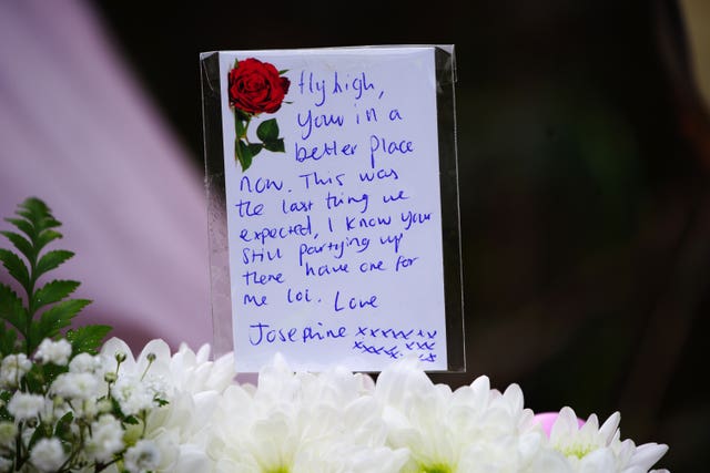 Floral tributes have been left at the scene to those who died (Ben Birchall/PA)