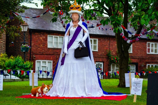 A life-sized knitted Queen and corgi in the village of Holmes Chapel in Cheshire