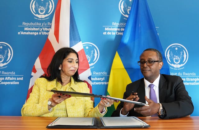 Home Secretary Suella Braverman and Rwandan minister for foreign affairs and international co-operation, Vincent Biruta sign an enhanced partnership deal in Kigali in March