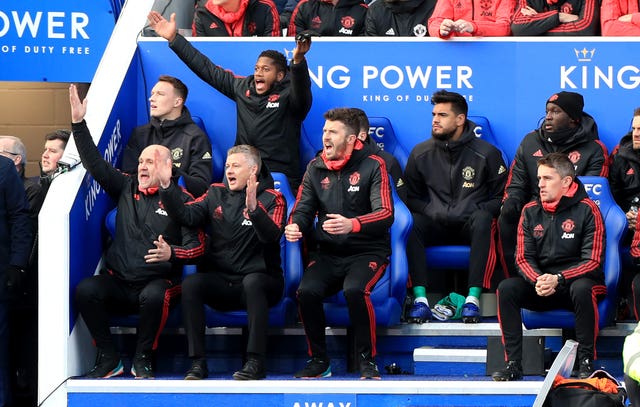 Ole Gunnar Solskjaer, second left, and the United staff react
