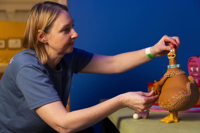 A woman with a Chicken Run character