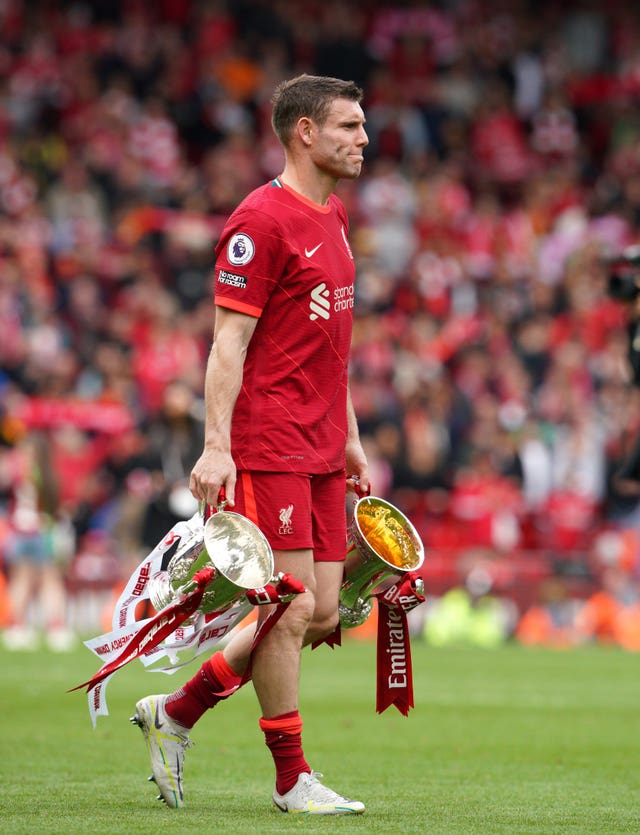 James Milner carries the Carabao Cup and FA Cup as Liverpool thank their fans after the Premier League match against Wolves
