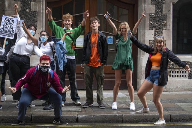 A-level students celebrate outside the Department for Education in London after it was confirmed that candidates in England will be given grades estimated by their teachers