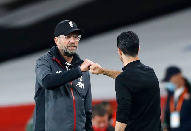 Liverpool manager Jurgen Klopp, left, is preparing to face Arsenal manager Mikel Arteta