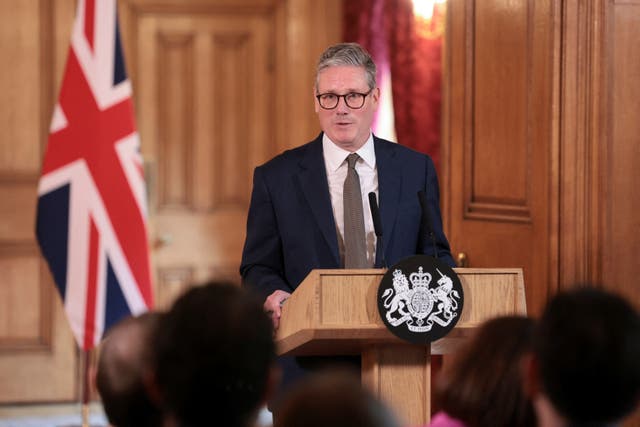 Prime Minister Sir Keir Starmer speaks at a lectern in front of a Union Flag