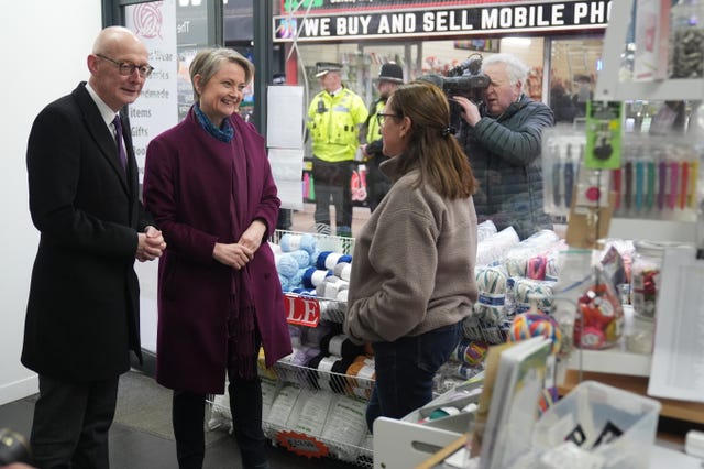 Yvette Cooper and Pat McFadden speak to retailers during a visit to Bilston in the West Midlands 