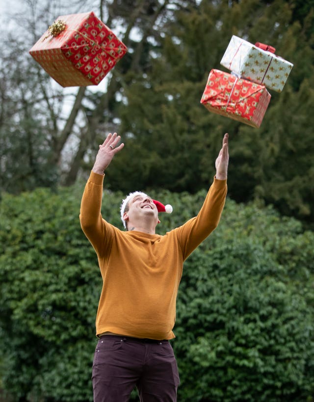 Mr Pirags throws presents into the air