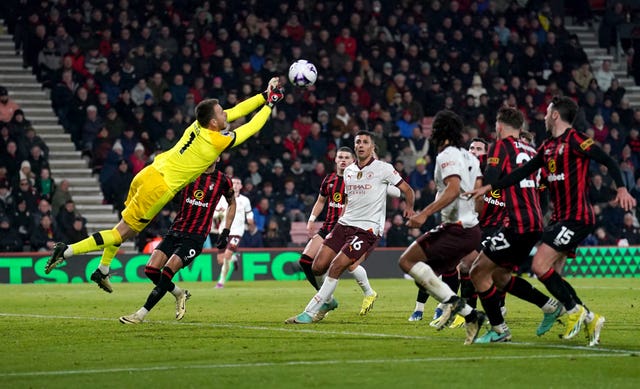 Players watch as Bournemouth goalkeeper Neto punches the ball clear