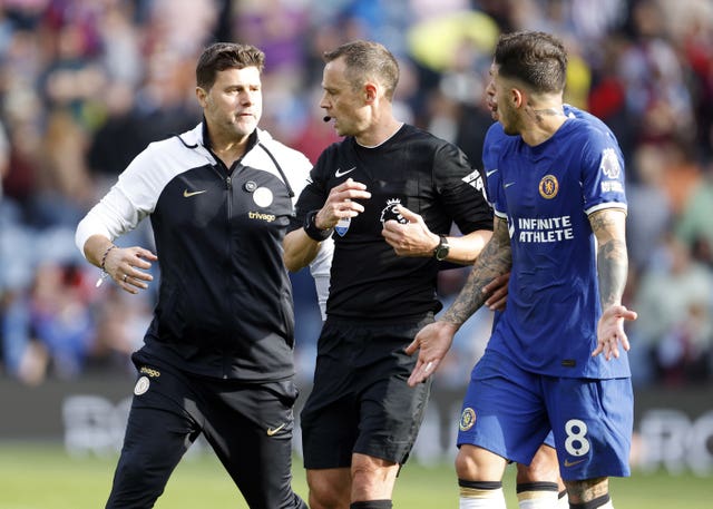 Chelsea manager Mauricio Pochettino speaks to referee Stuart Attwell at half-time during his side's win at Turf Moor 
