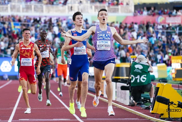 Jake Wightman crosses the line to win 1,500 metres gold