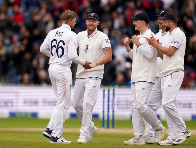 Joe Root (left) is congratulated by his England team-mates