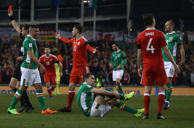 Coleman holds his leg after a challenge from Wales’ Neil Taylor