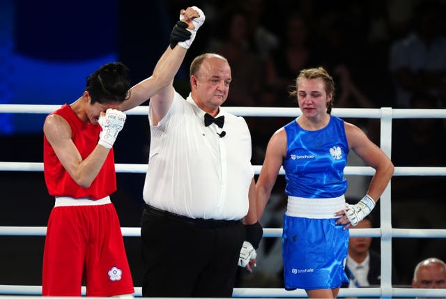 Lin Yu-ting has her hand raised in the Olympic women's featherweight final