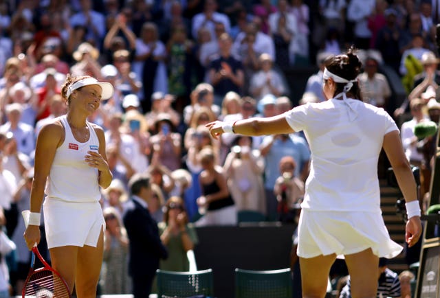 Ons Jabeur (right) gestures for the crowd to applaud Tatjana Maria after their match 