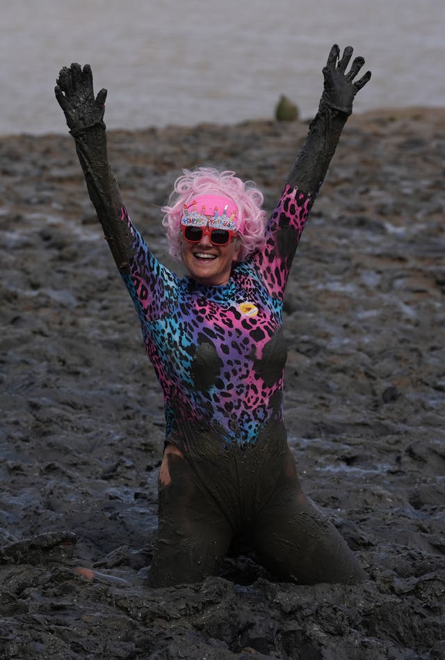 A competitor takes part in the annual Maldon Mud Race, a charity event to race across the bed of the River Blackwater in Maldon, Essex