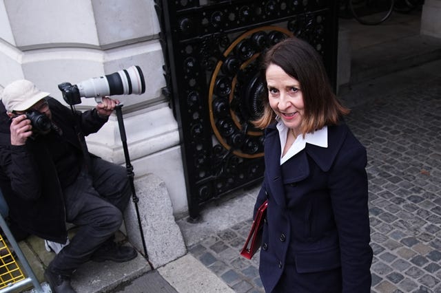 Liz Kendal smiling while exiting a building