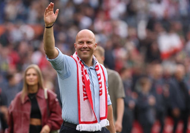 Arne Slot, with a Feyenoord scarf around his neck, waves to the crwod