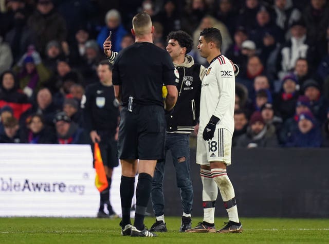 Casemiro has a selfie with a pitch invader at Selhurst Park