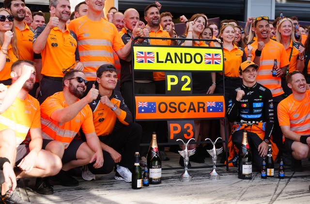McLaren's Norris (centre left) and Oscar Piastri (centre right) celebrate with the team after taking second and third respectively