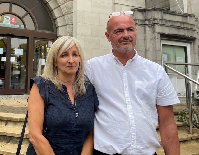 A woman and a man standing outside a building