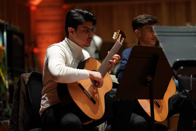 Afghan Youth Orchestra guitarist performs