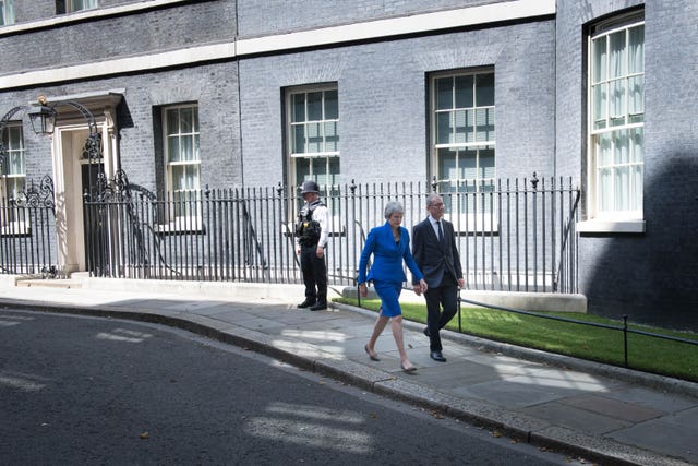 Outgoing prime minister Theresa May and her husband Philip leaving 10 Downing Street, London, before a meeting at Buckingham Palace where she handed in her resignation to the Queen