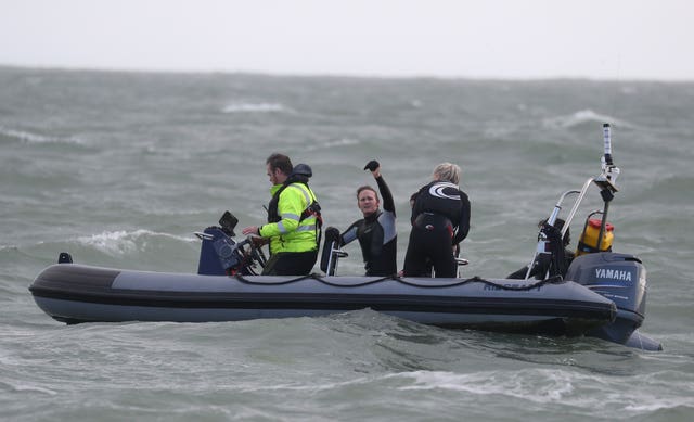 Former paratrooper John Bream, centre, waves after his helicopter jump