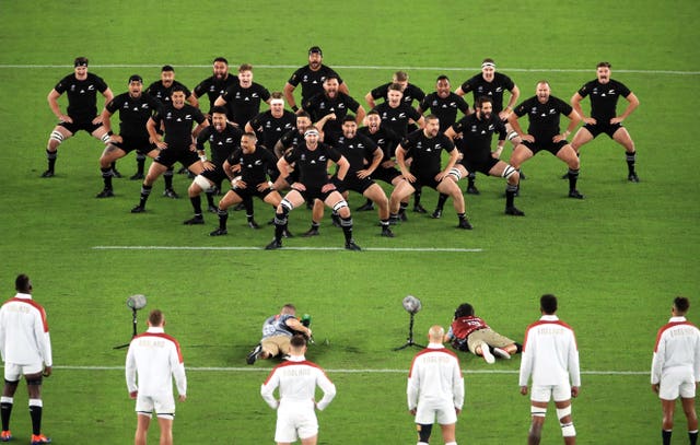 New Zealand perform the Haka in an arrowhead formation as England form a V shape in response