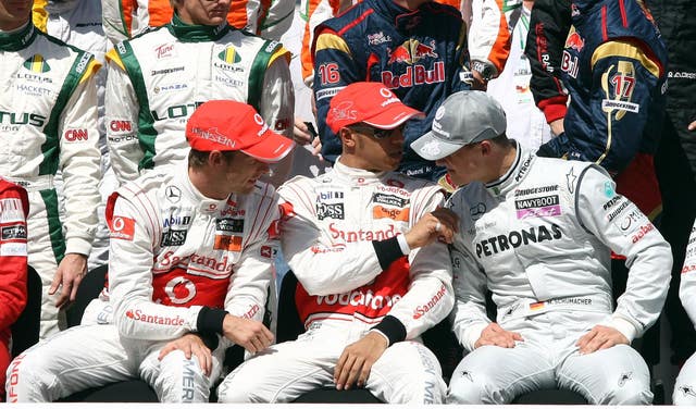 Schumacher chats to McLaren pair Jenson Button and Lewis Hamilton ahead of the 2010 season.