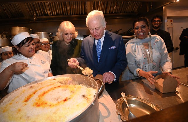 Charles and Camilla help pack donation boxes