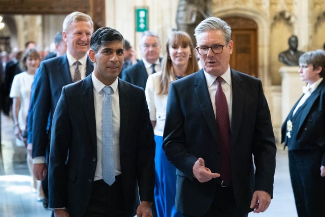 Sir Keir Starmer walks next to Rishi Sunak in front of Oliver Dowden and Angela Rayner inside Palace of Westminster