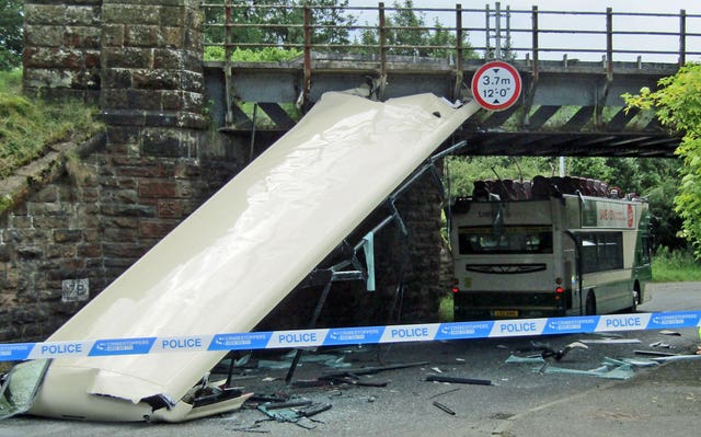A double decker Lothian country bus that lost its roof after it hit a railway bridge in Shotts Road in Fauldhouse, West Lothian